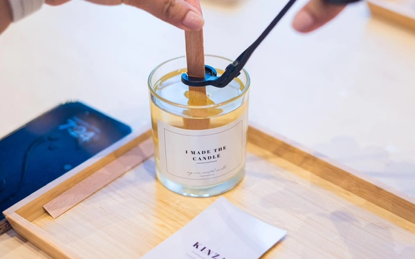 Employees making handcrafted candles during a corporate team building workshop in Dubai