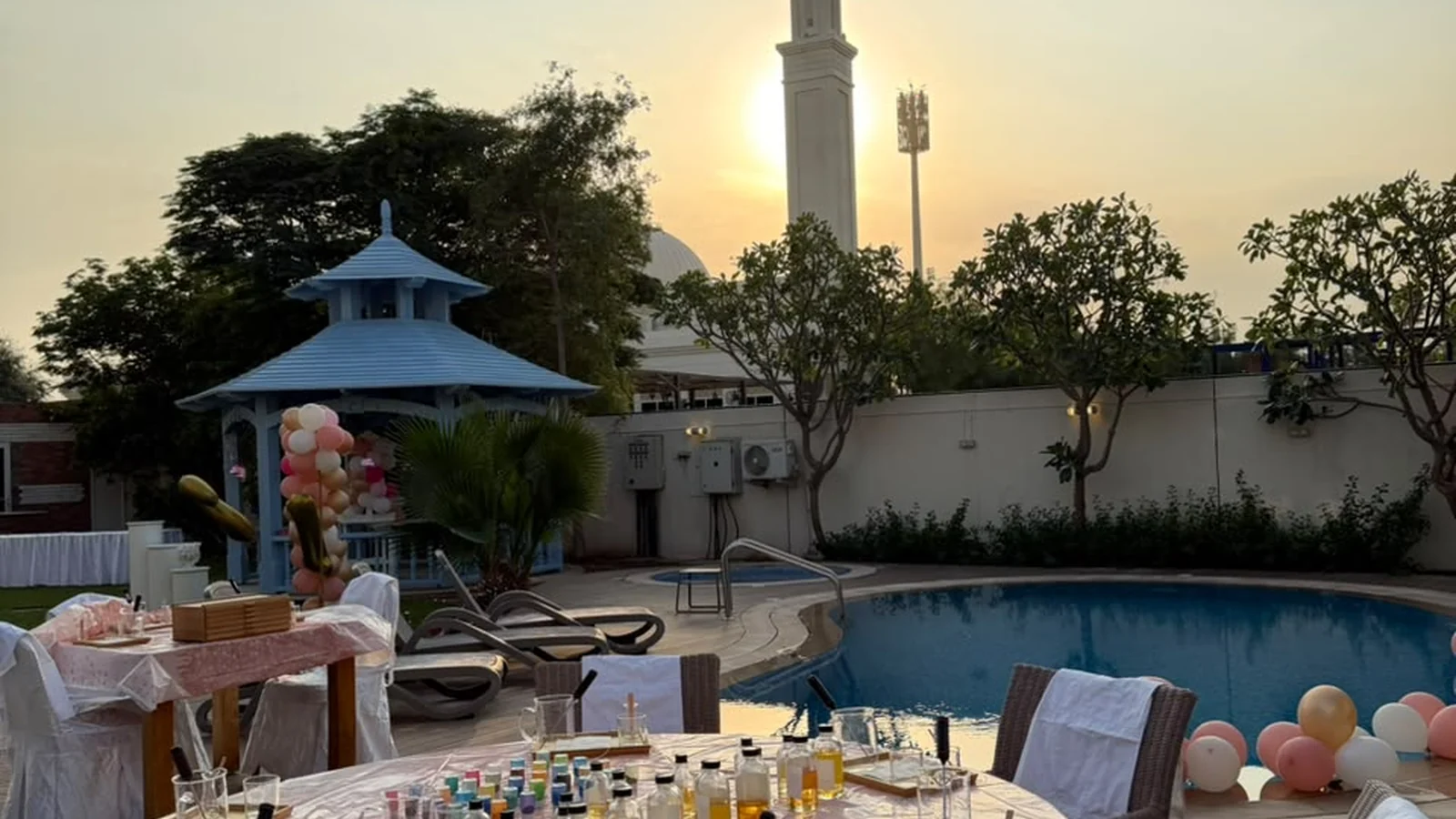 Studio Kinza facilitator assisting a child with safe wax pouring at a kids candle workshop in Dubai