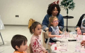Children crafting colorful scented soy candles during an indoor kids activity in Dubai