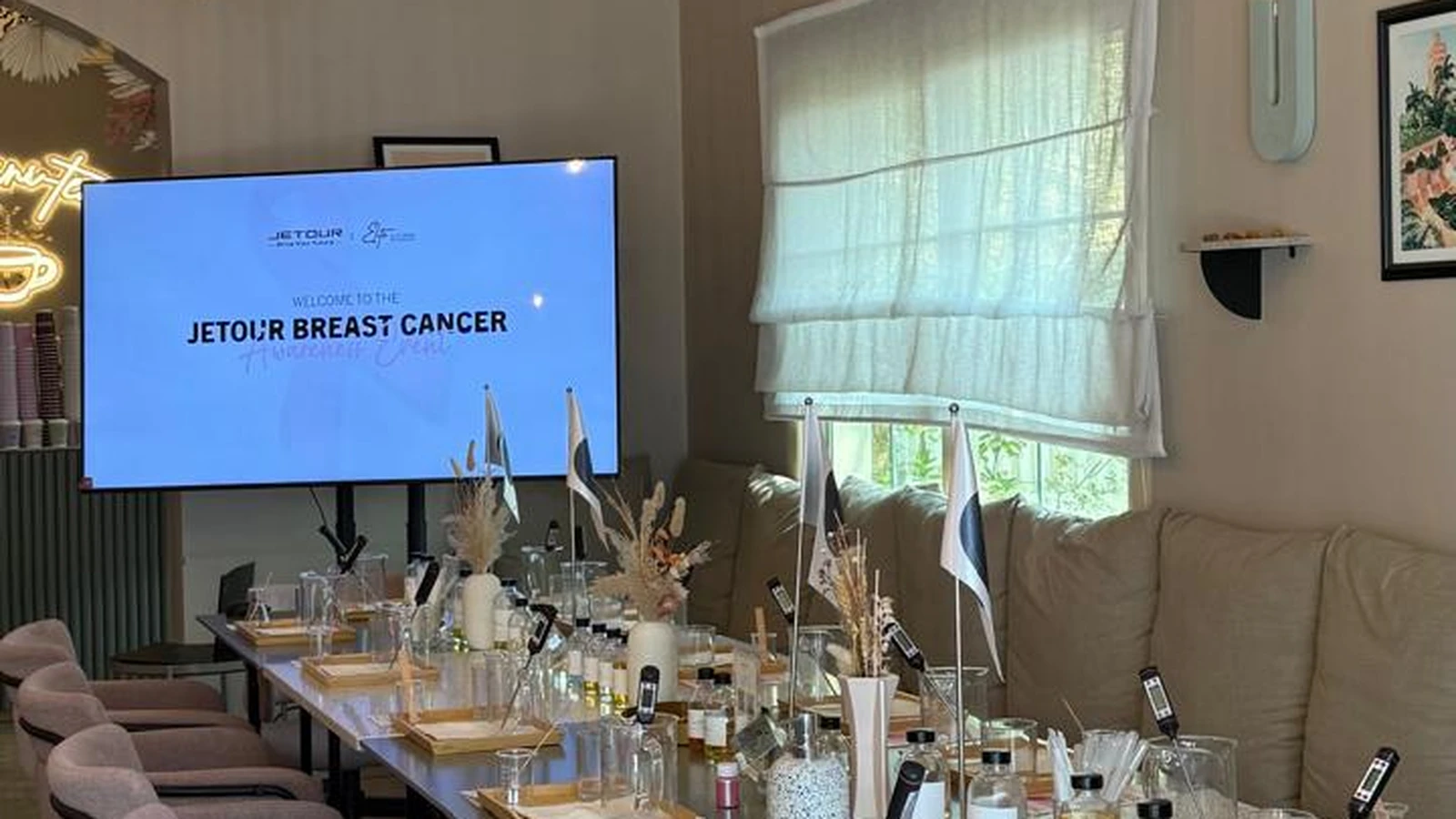 Bespoke candle-making setup with soy wax pitchers, amber jars, and fragrance oils arranged for a corporate team event.
