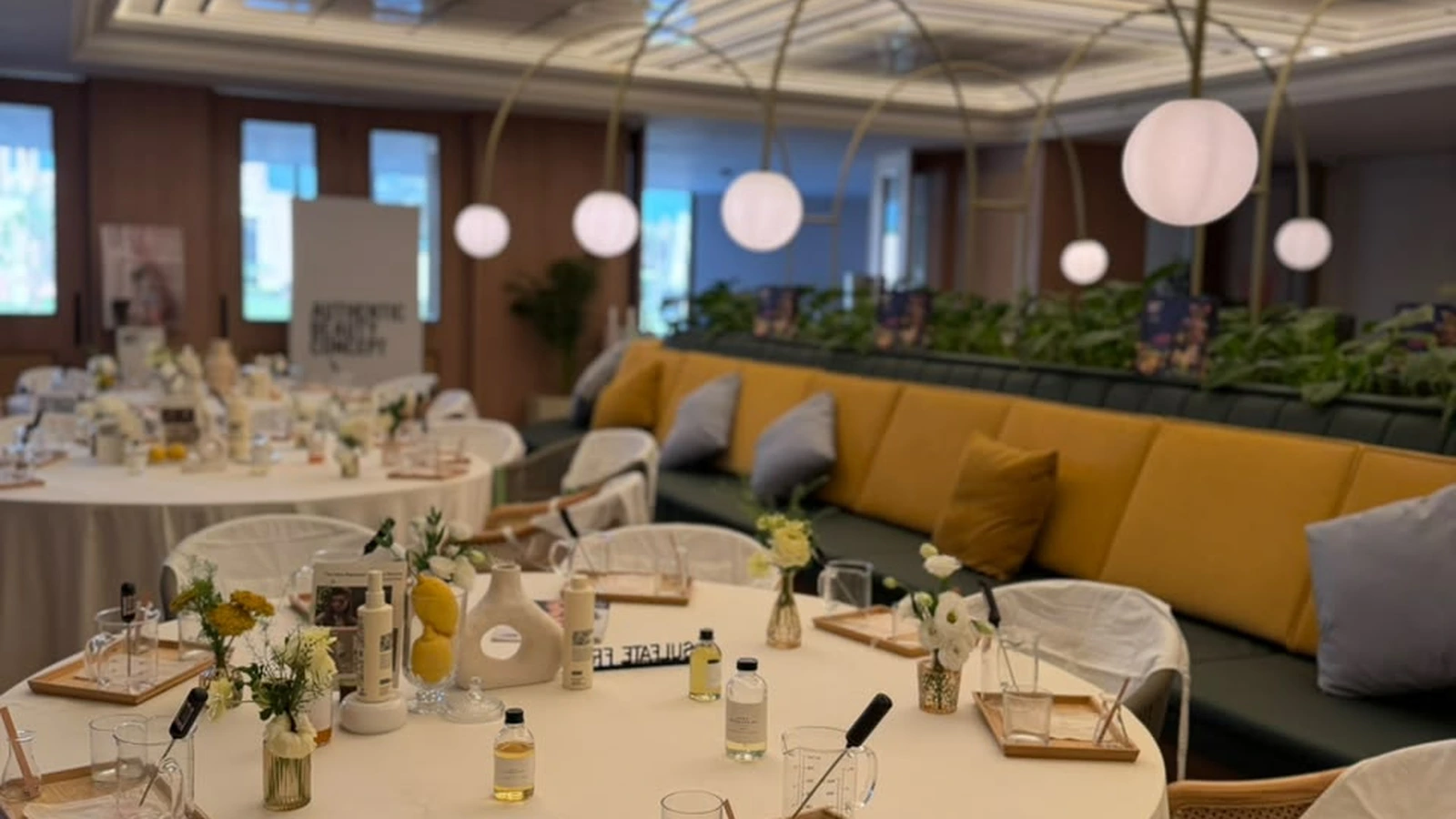 Luxury executive offsite table setting with candle-making materials, fragrance vessels, and premium tea service in Dubai.