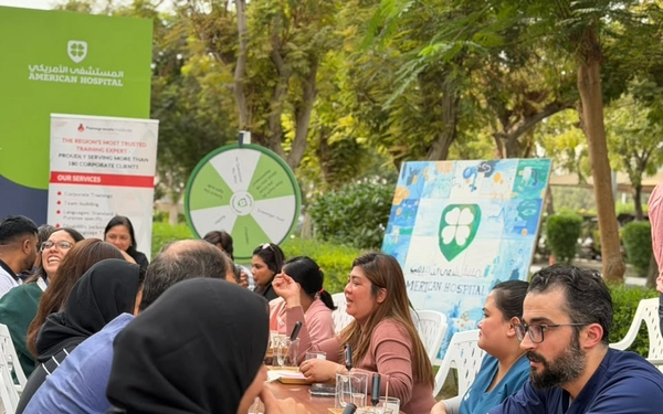 Measure Roi Experiential Team Building Workshops 16 HR professionals and corporate teams analyzing engagement metrics and collaborating in an experiential workshop in Dubai.