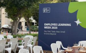 Hybrid team colleagues reconnecting in person during a creative candle-making workshop in Dubai