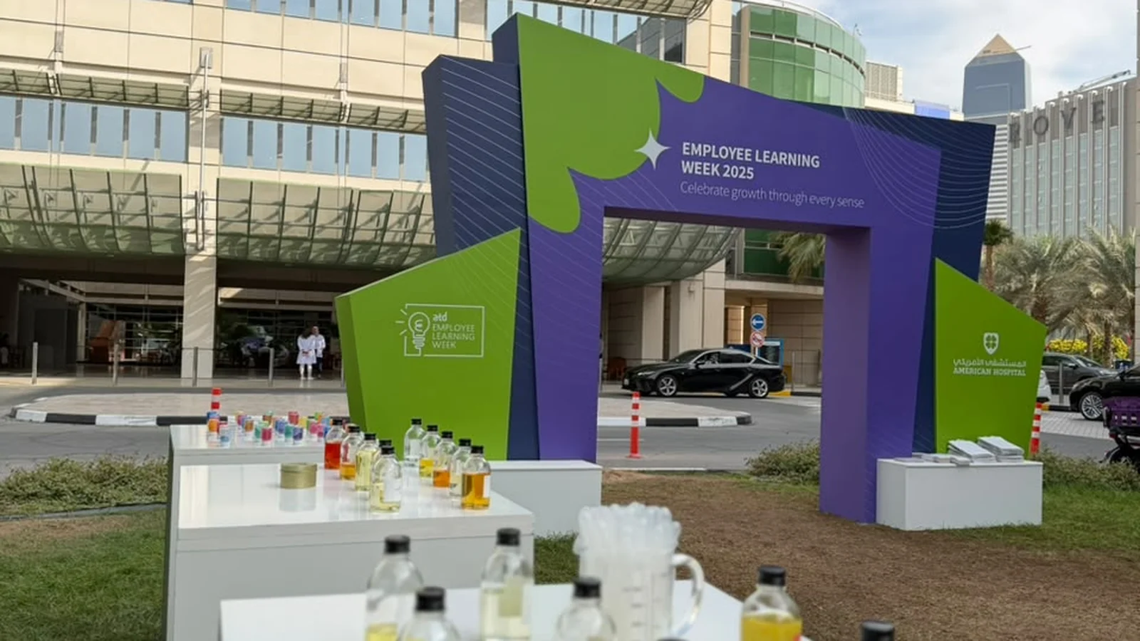 Team gathered around an ambient creative workshop table with soy wax and fragrance oils in Dubai
