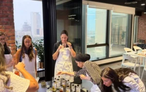 International wedding guests creating bespoke souvenir soy candles at a destination wedding in Dubai