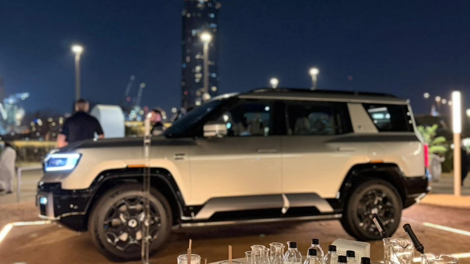 Elegant candle station with attendees browsing fragrances during an indoor event in Dubai