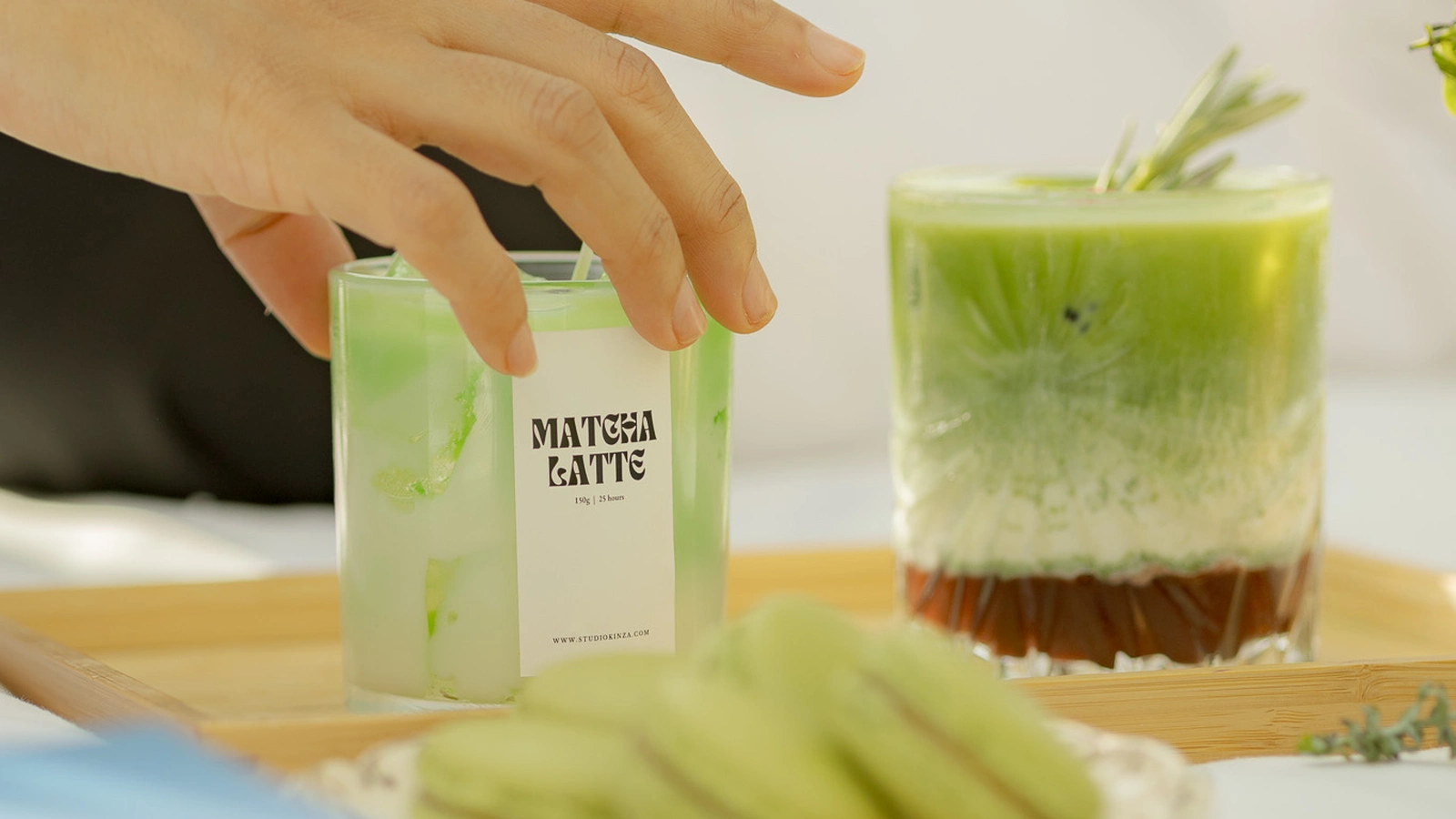Smartphone showing a Studio Kinza instant digital gift voucher next to a hand-poured soy candle in Dubai