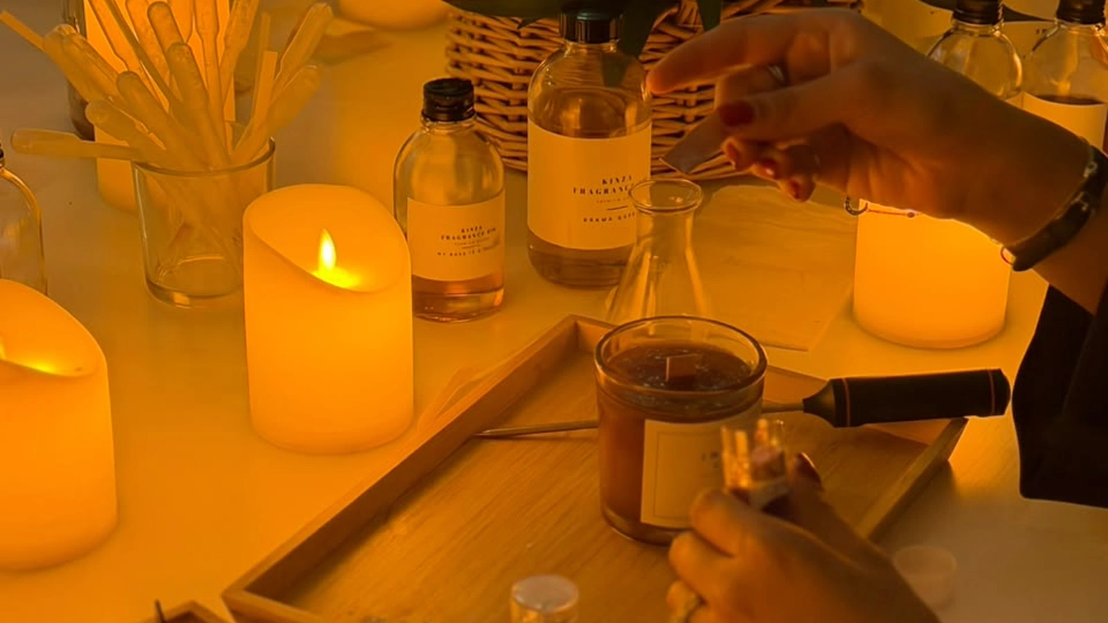 Couple blending custom fragrances and pouring soy candles together at a workshop in Dubai