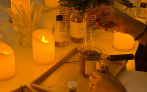 Romantic candle making atelier setup with amber jars, fragrance droppers and warm lighting in Dubai