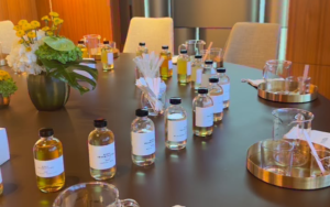 Minimalist luxury corporate gift display featuring custom-branded candles and digital experience gift vouchers in Dubai