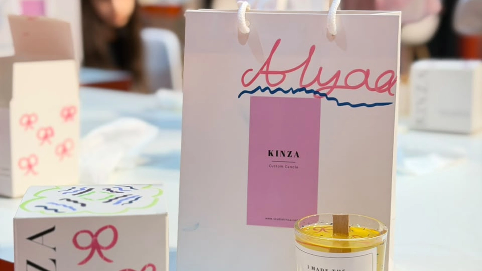Studio Kinza artisan workshop space arranged with scent accords, amber glassware, and gift cards in Dubai