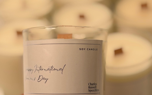 Candle Making Basics: How to Choose the Right Wick for a Homemade Candle 1 Measuring and centering a braided cotton candle wick in a glass amber jar before pouring wax