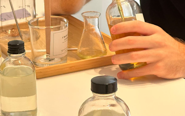 Fragrance for Candle Making: How to Layer Scents Without Making the Blend Overwhelming 36 Pipette blending two complementary fragrance oils into melted soy wax for custom candle making