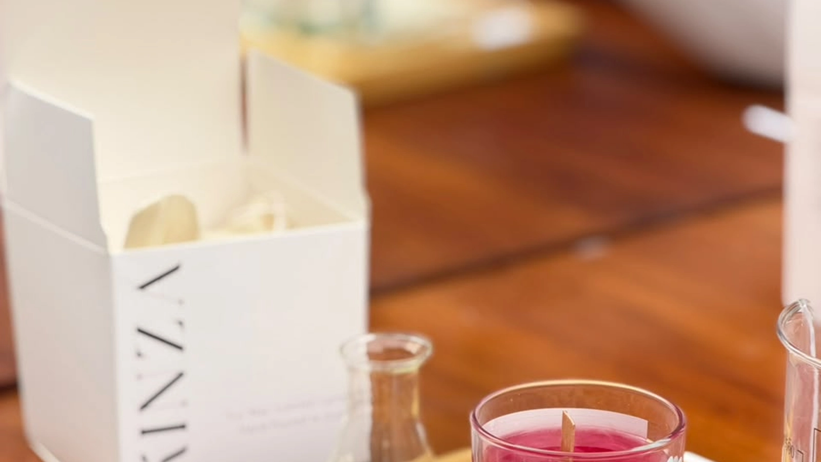 Teen birthday guests exploring fragrance oils and blending scents at a candle workshop table in Dubai