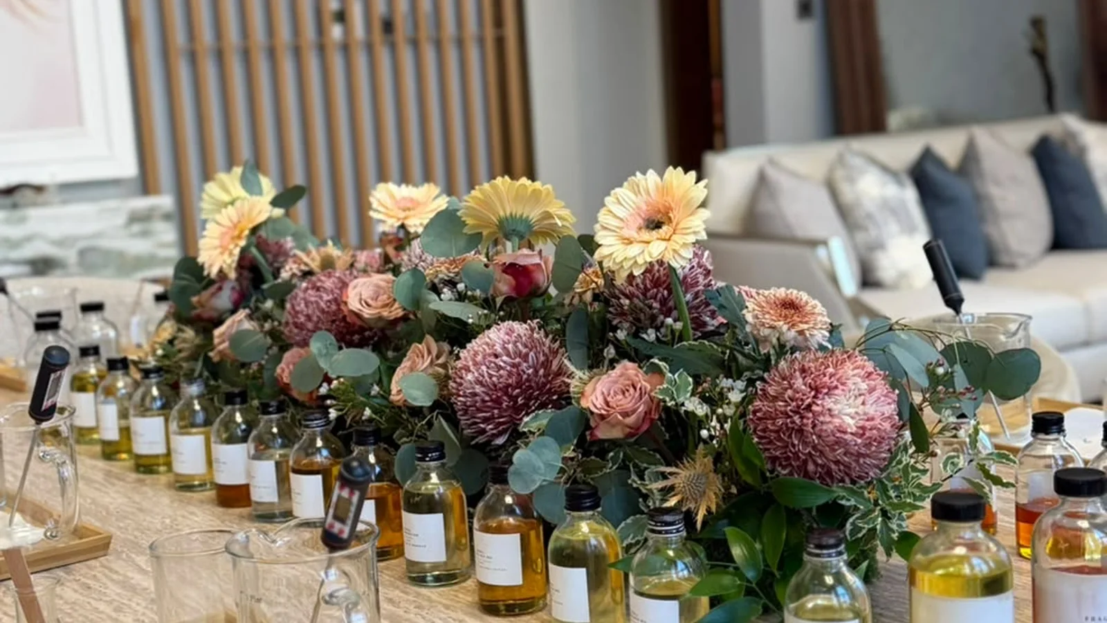 Studio Kinza workshop table setup with molten soy wax, fragrance droppers, and digital gift vouchers in Dubai