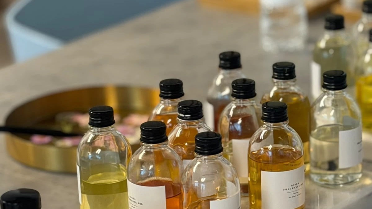 Adults blending custom scented oils and pouring candles during an Eid Al Etihad workshop in Dubai